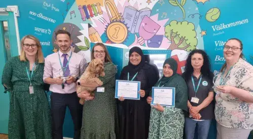 Staff holding awards from Ark Schools in 2023